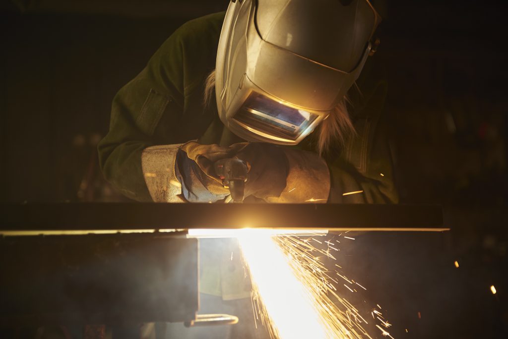 Image of fabricator welding metal.