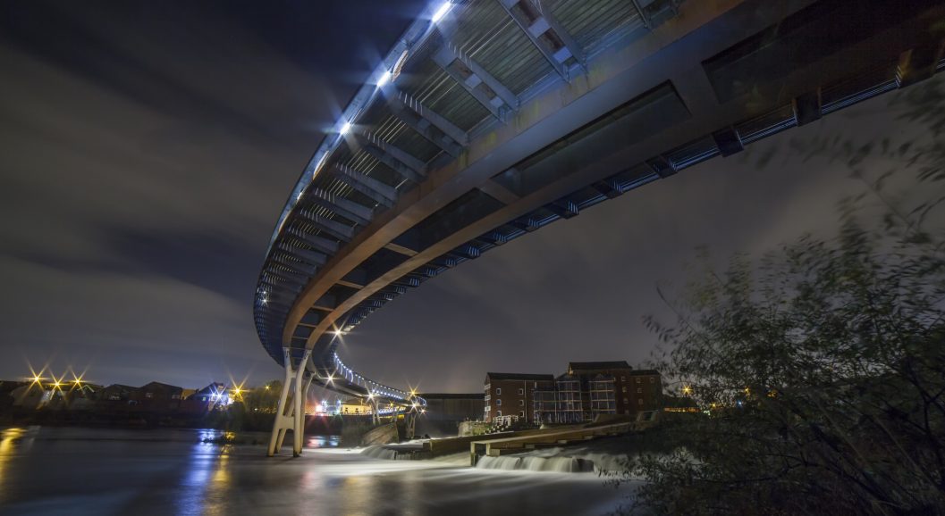 Castleford Footbridge Castleford Footbridge over the River Aire in West Yorkshire on the 10 November 2018.A beautiful night besides the river as the water is flowing under the bridge.The old stone ground floor mill can also be seen which is a big part of Castlefords heritage.